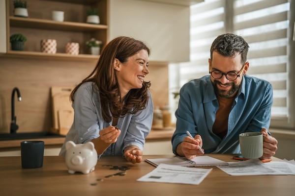 Happy couple budgeting and planning home finances