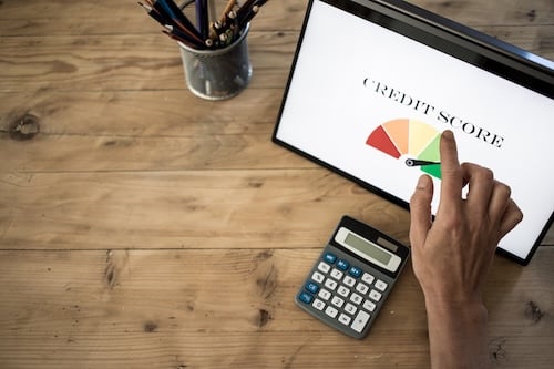 online finances hand pressing credit score button on tablet