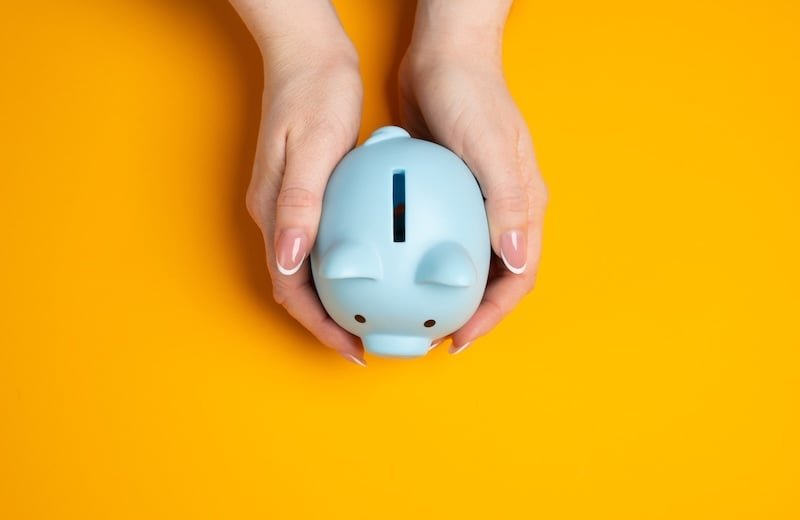 Piggy bank in hands. Concept of savings. Financial security, saving money, and smart budgeting.