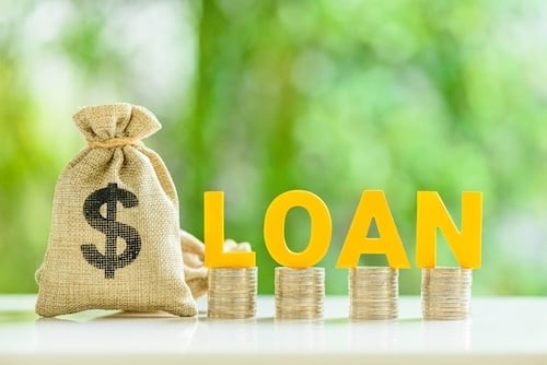 Consumer and personal loan, financial concept : Loan bags, row of coins with the word LOAN on a table, depicting financial flexibility for life's expenses, unlock borrower's goal with personal loan.