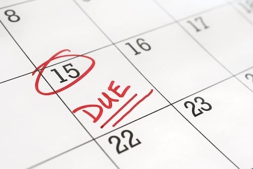 Calendar with the 15th of the month circled and word DUE written on it