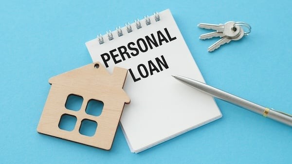 On the blue surface there is a notebook with an inscription Personal loan