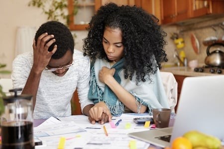 Worried Couple Reviewing Finances at Home