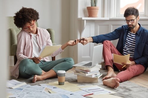 Couple Working Together on Floor at Home
