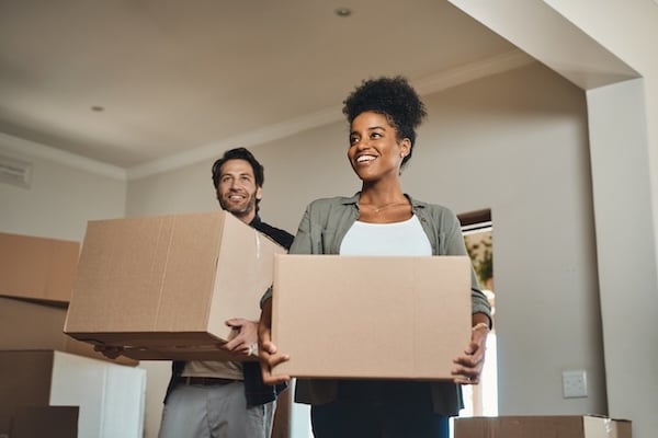 young adult couple carrying moving boxes Adobe stock photos