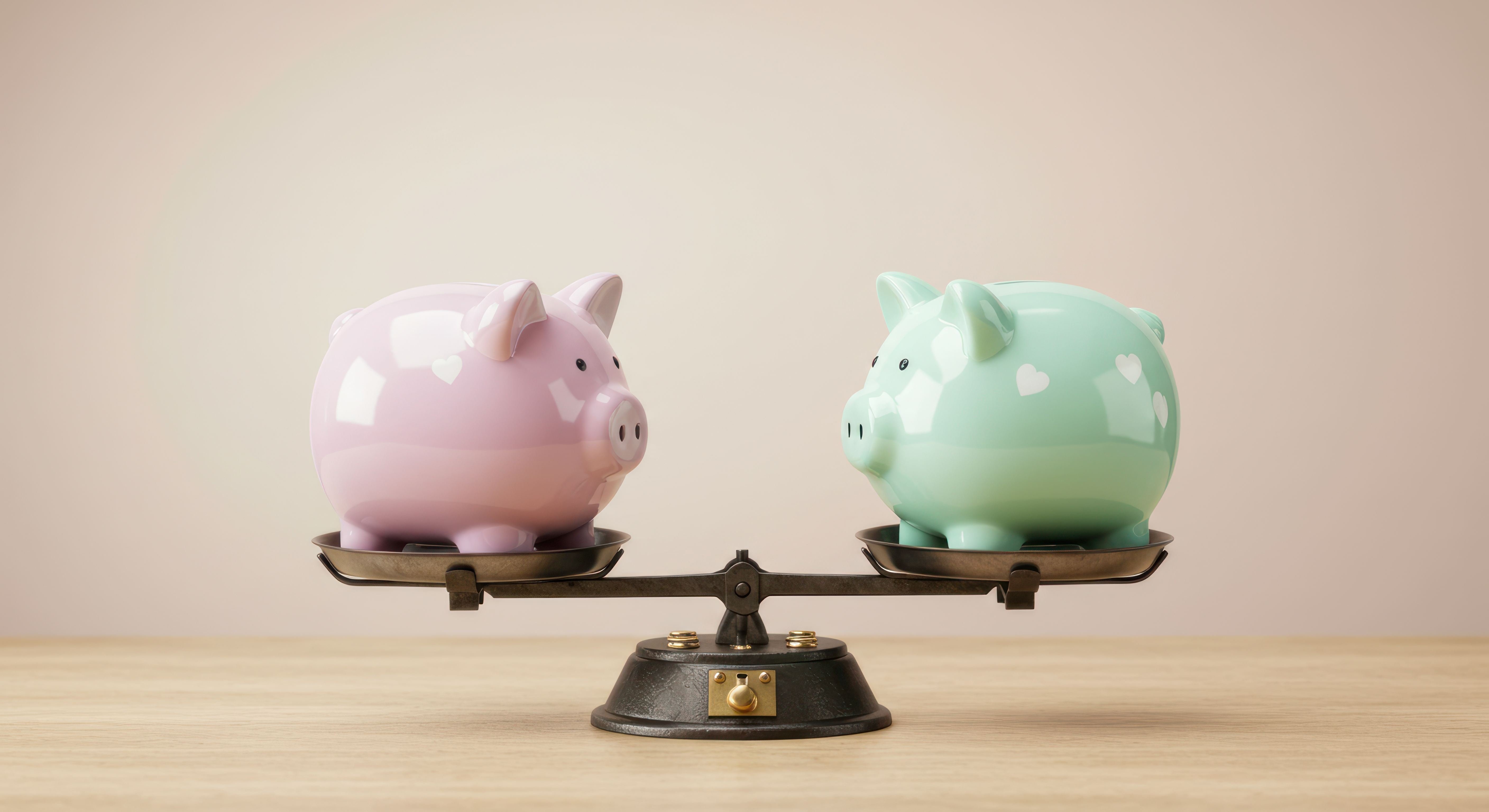 Two piggy banks on a balance scale representing financial comparison or savings.