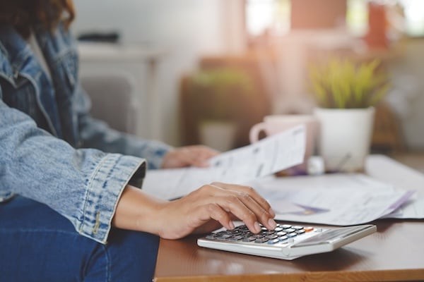Financial household debt economy accounting concept. Close up view hands of person calculating monthly expense and management investment and payment bill invoice.