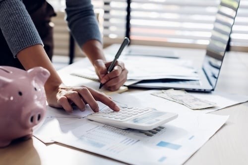 Financial Planning with Calculator and Paperwork at Desk