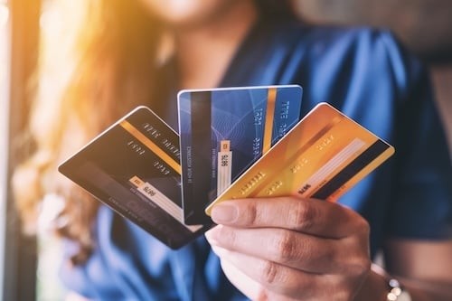 Woman Holds Credit Cards in Indoor Setting