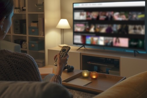 Woman Relaxing at Home Watching Streaming Service