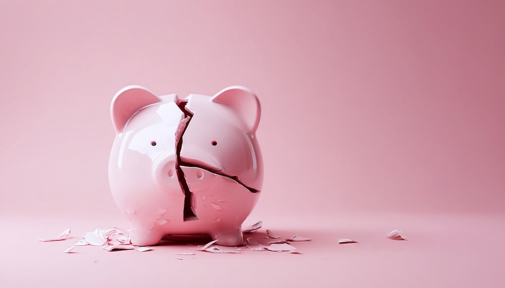 Broken piggy bank with coins money isolated on pink background, close-up. Finance, saving money for travel. Empty