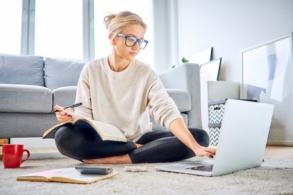 woman_sitting_on_floor_working_on_laptop_budgeting
