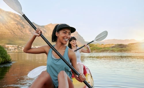 women kayaking while on summer vacation