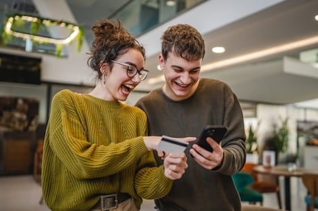 young adult couple credit building Adobe stock photo